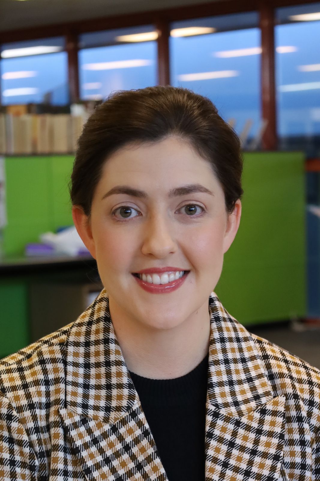 Headshot of Jane with an office background.