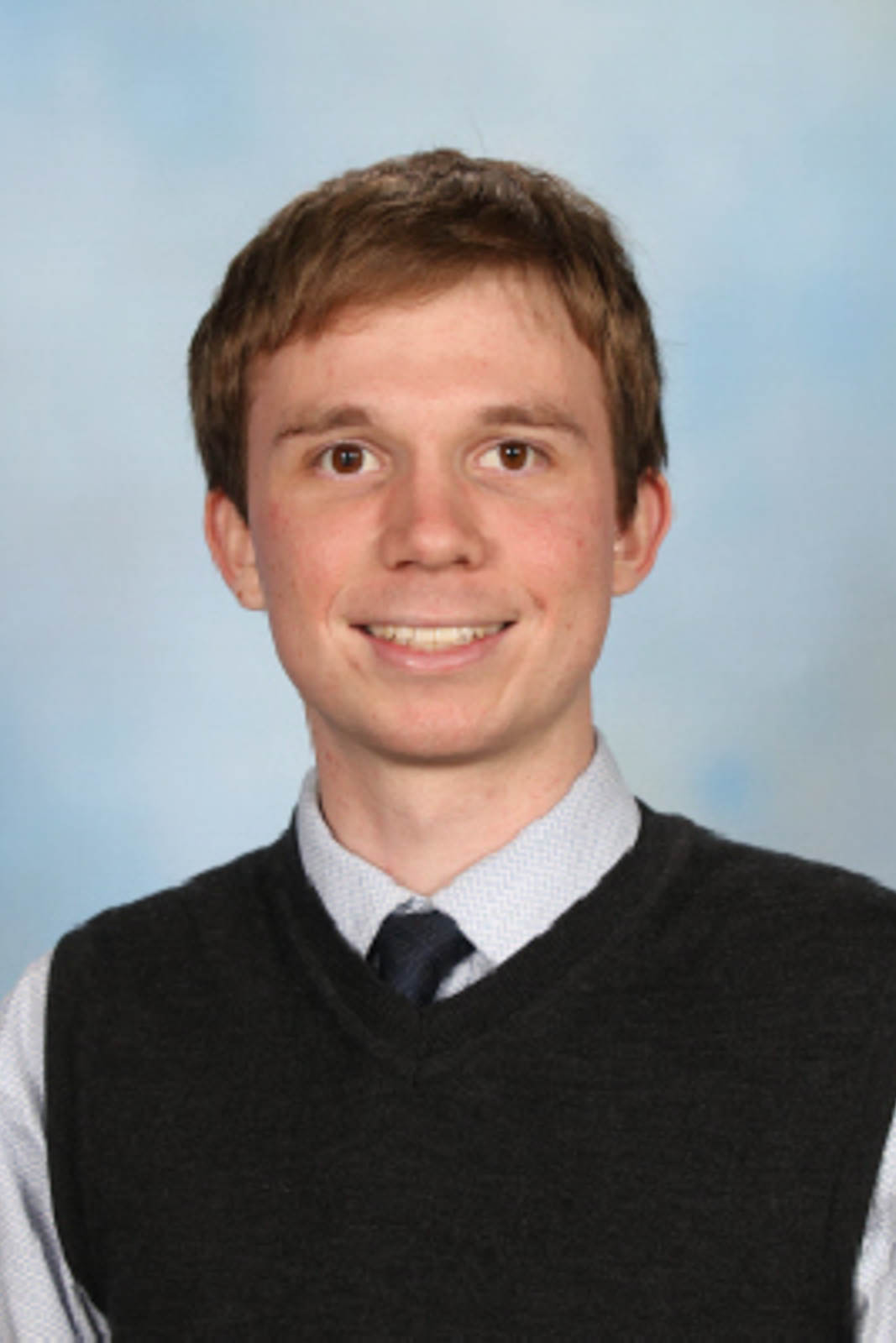 Headshot of Bradley in a black jumper vest.