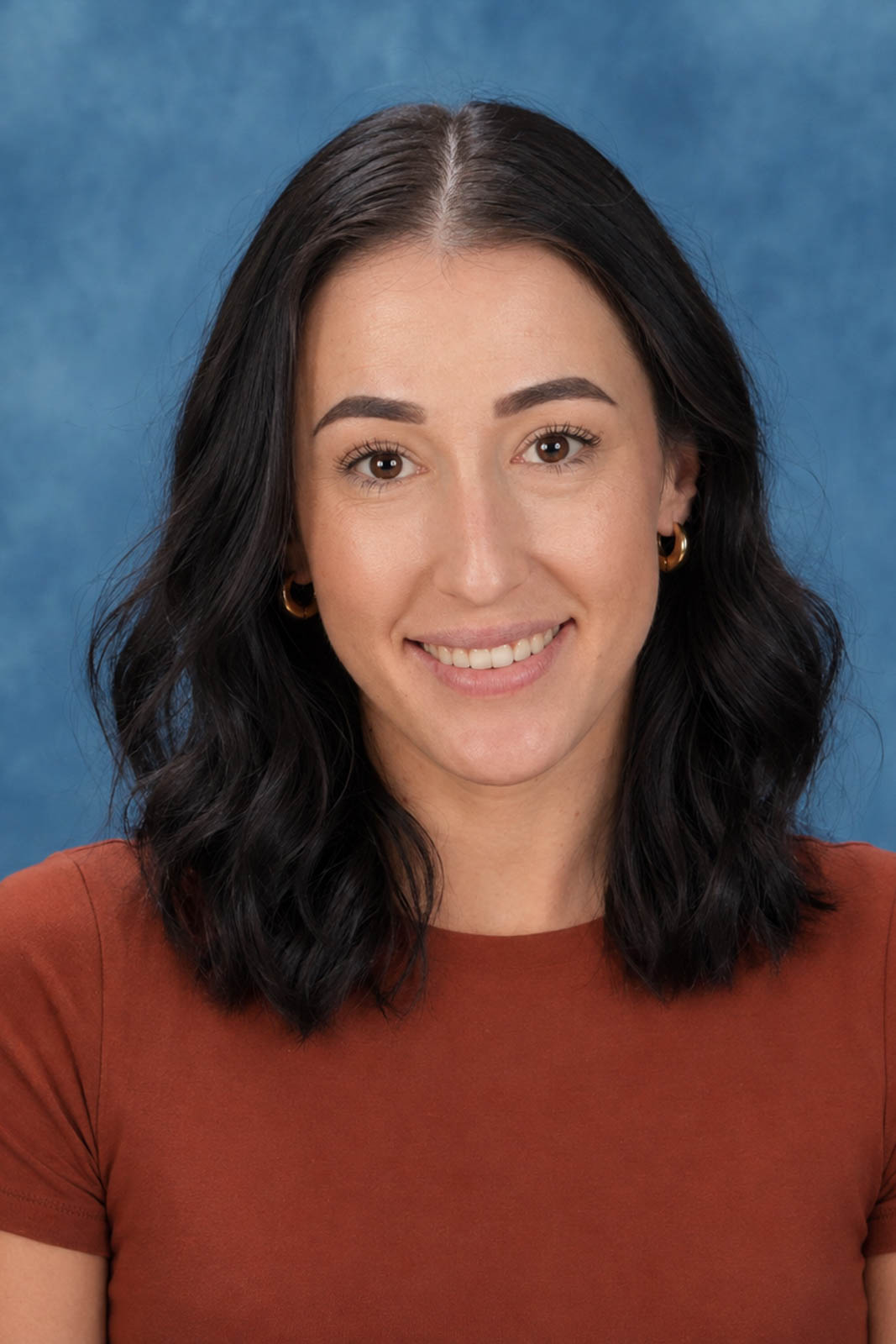 Headshot of Nikiesha in an orange top.
